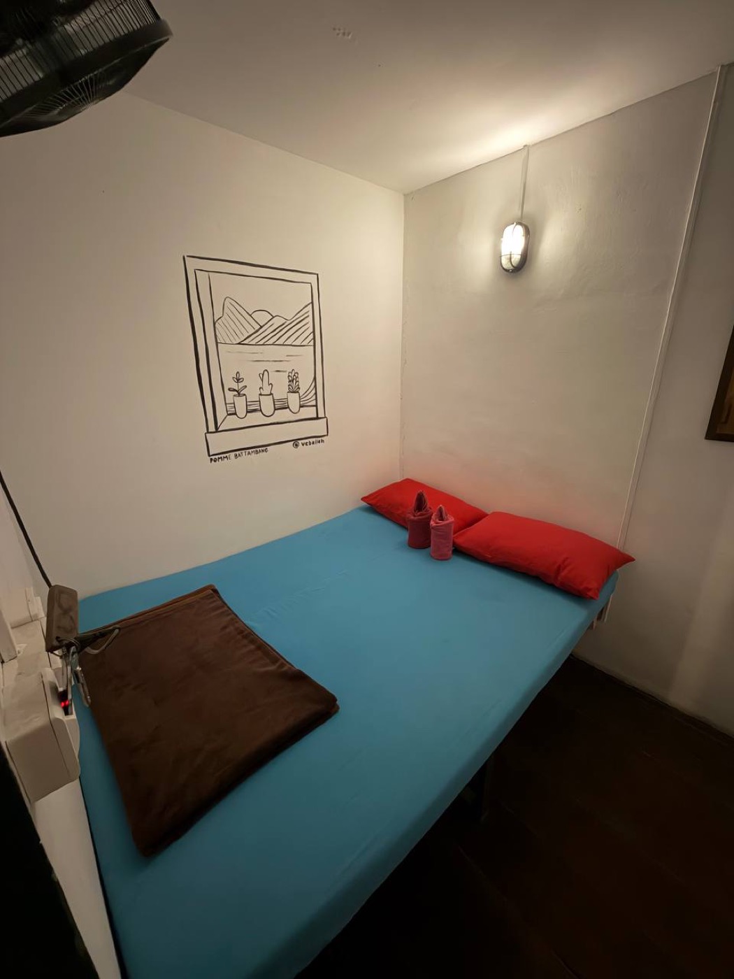 Inside a private sleeping cabin, made up with a bed and reading light