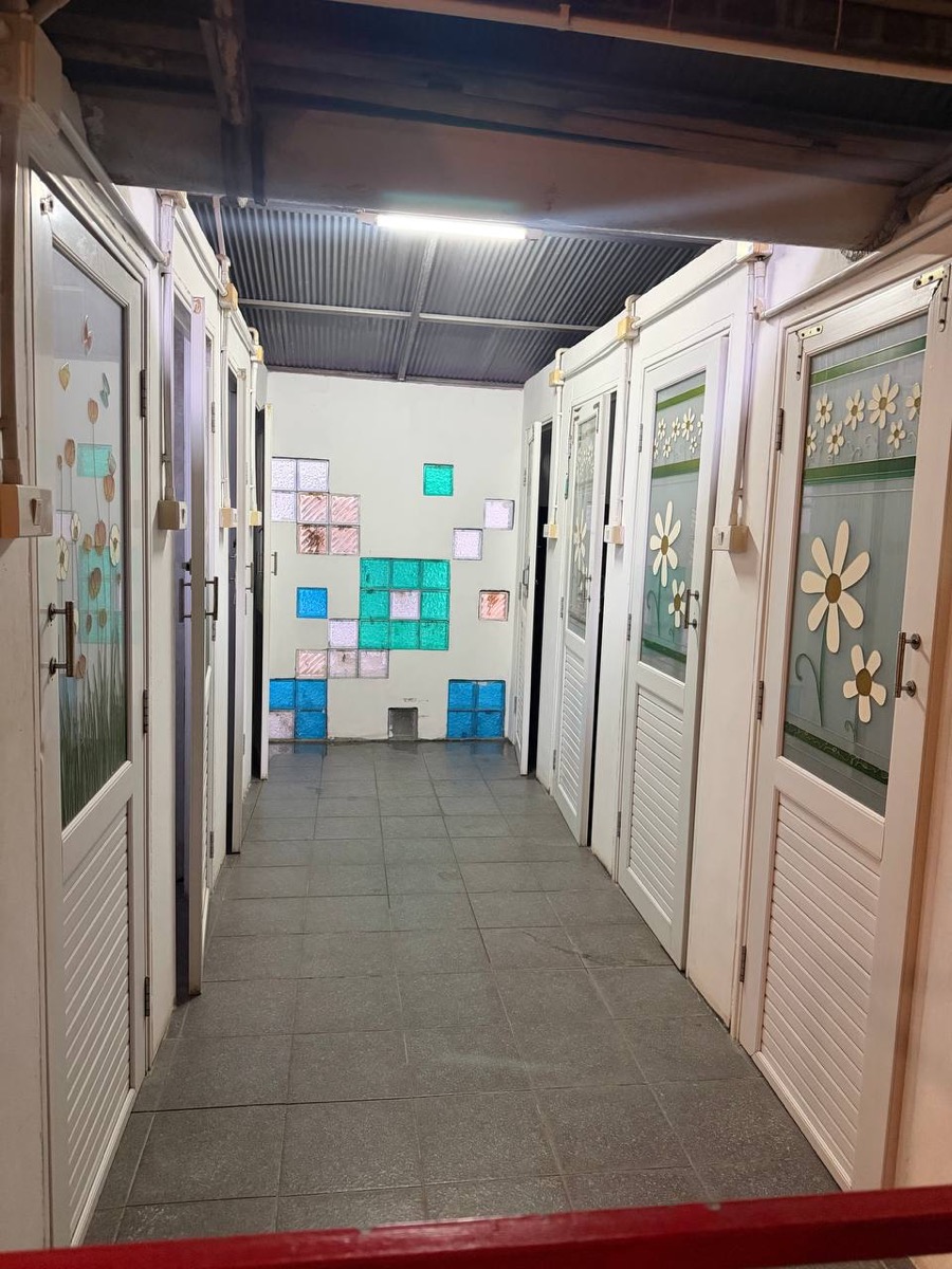 The shared bathrooms upstairs, with a coloured glass block wall