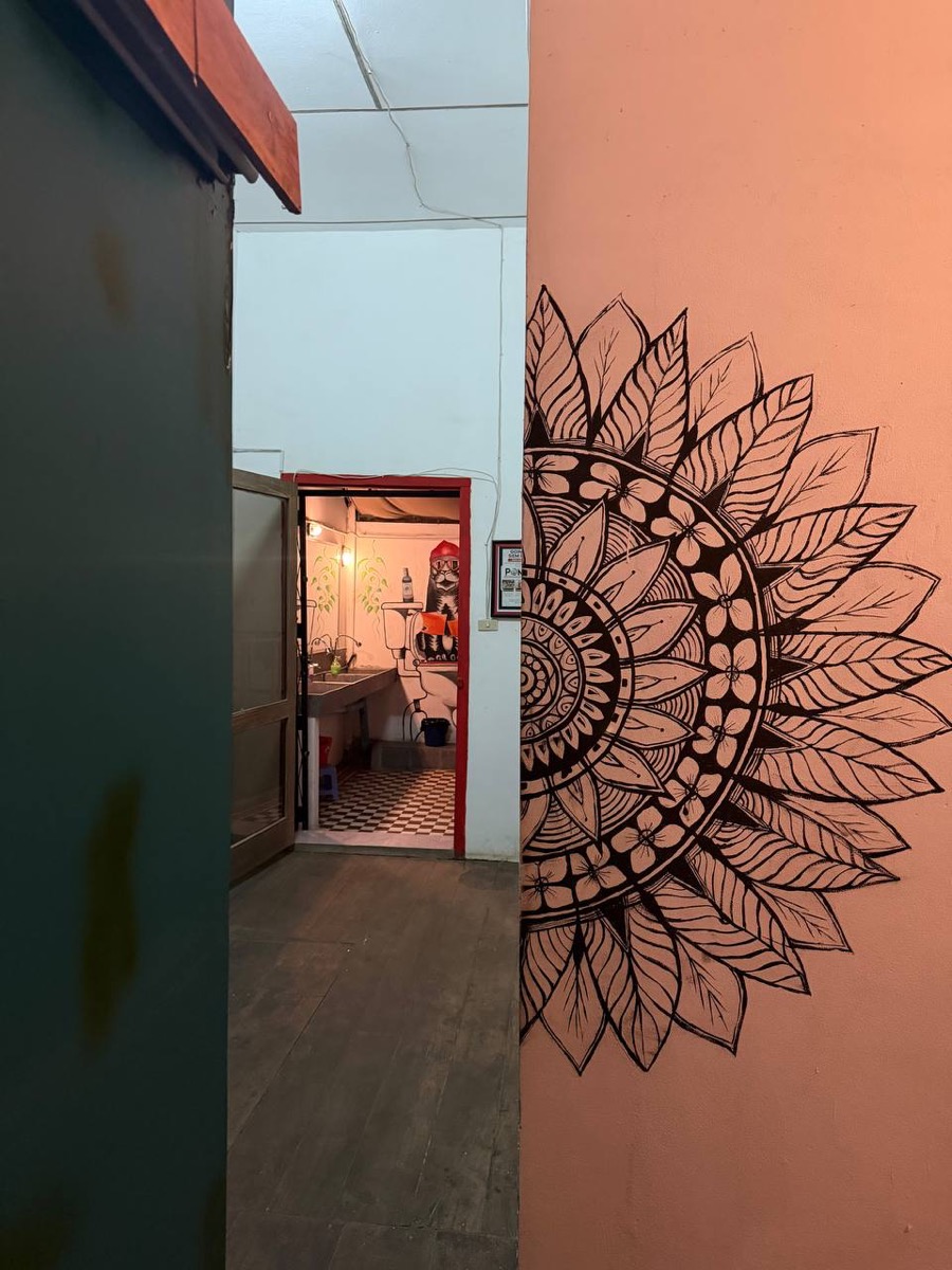 A large mandala painted on the wall of the upstairs landing